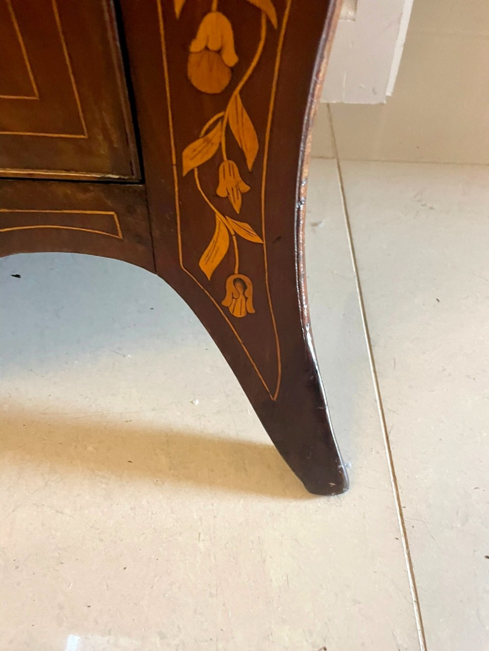 An 18th-century mahogany cylinder bureau decorated with detailed floral marquetry inlay across the curved roll-top and three lower drawers. View XII