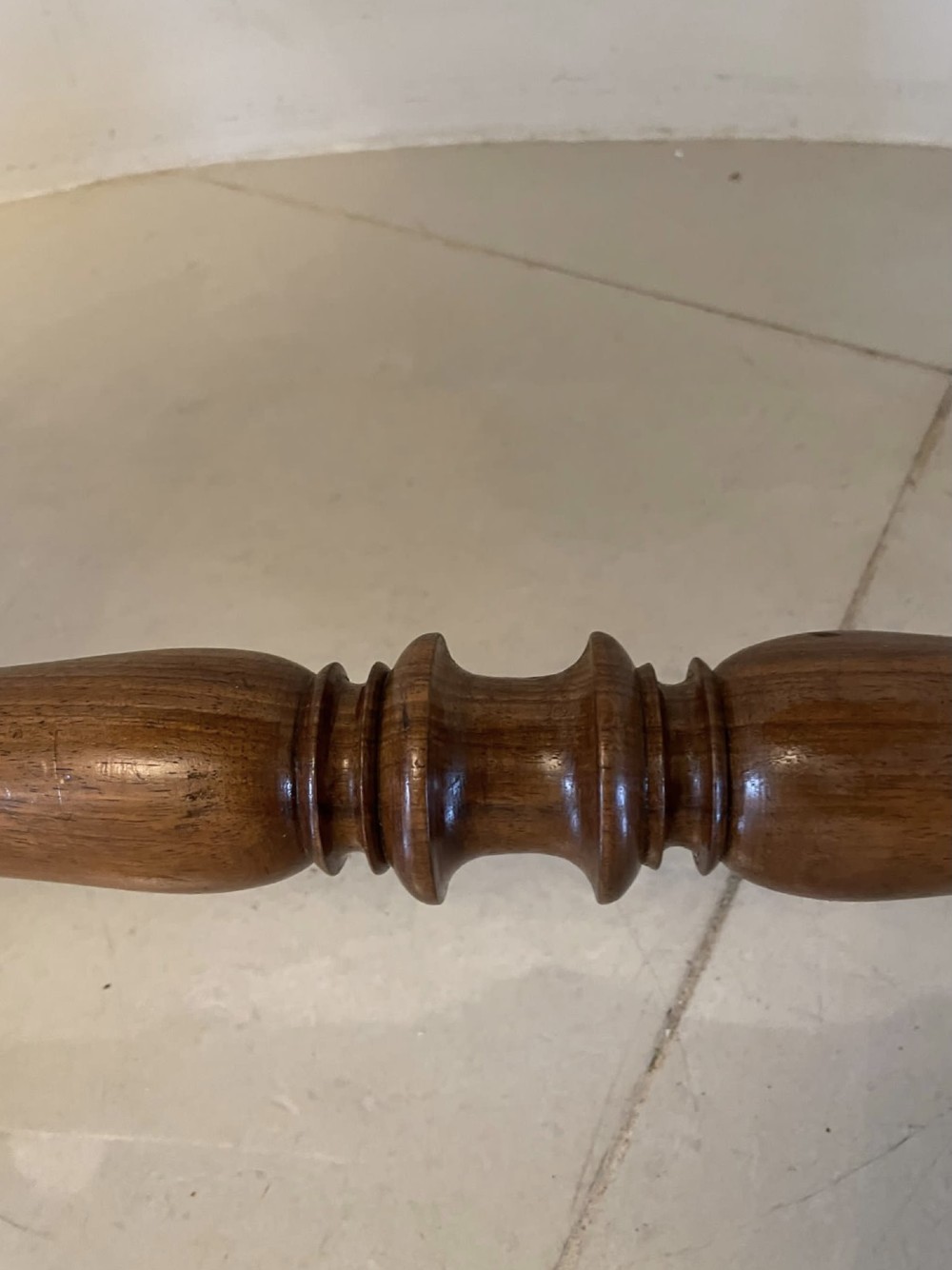 A Victorian burr walnut centre table with a serpentine shaped top, resting on carved pierced end supports and connected by a turned stretcher. View XIII