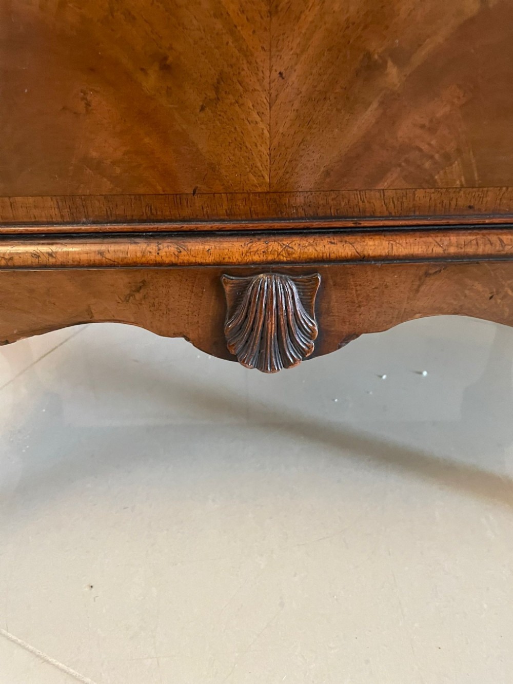 An antique burr walnut chest on stand featuring a two-door cupboard with arched panels above three long drawers, resting on carved cabriole legs. View IV