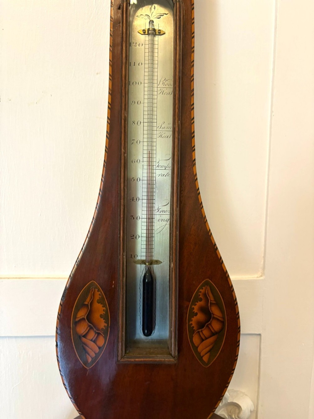 An antique George III mahogany banjo wall barometer featuring shell marquetry inlays, a silvered circular dial, an integrated mercury thermometer, and a broken-arch pediment with a brass finial. View III