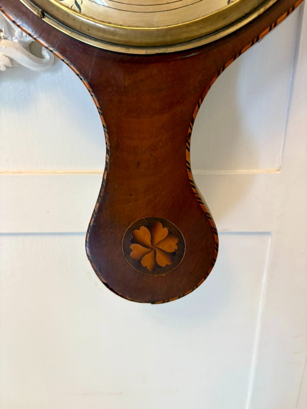 An antique George III mahogany banjo wall barometer featuring shell marquetry inlays, a silvered circular dial, an integrated mercury thermometer, and a broken-arch pediment with a brass finial. View VI