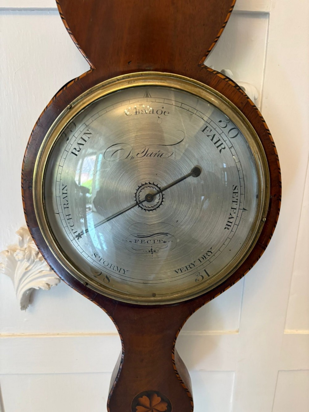 An antique George III mahogany banjo wall barometer featuring shell marquetry inlays, a silvered circular dial, an integrated mercury thermometer, and a broken-arch pediment with a brass finial. View VII