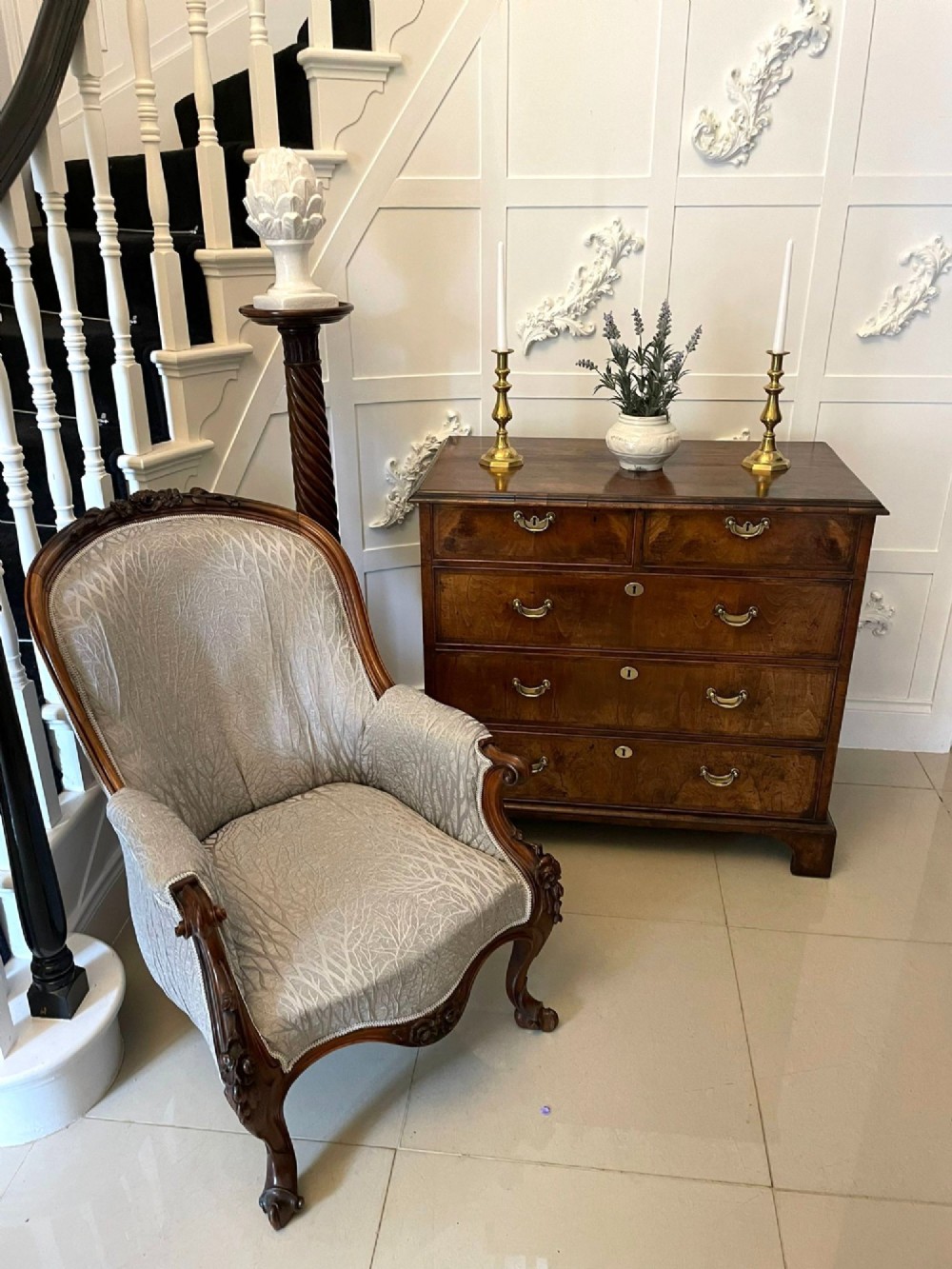 A George I period chest of drawers in figured walnut featuring two short drawers over three long drawers with brass drop handles and bracket feet. View VIII