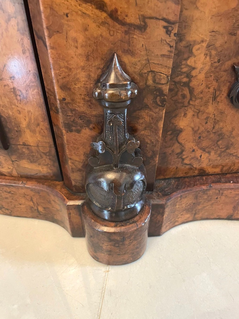 A Victorian burr walnut credenza featuring a serpentine white marble top, mirrored cupboard doors, and a large oval mirror back with carved scrolling detail. View IV