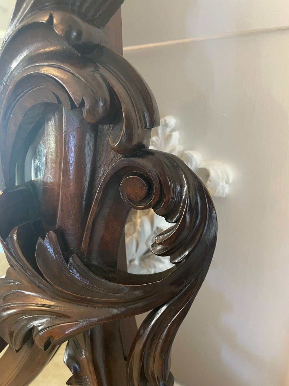 A Victorian burr walnut credenza featuring a serpentine white marble top, mirrored cupboard doors, and a large oval mirror back with carved scrolling detail. View V