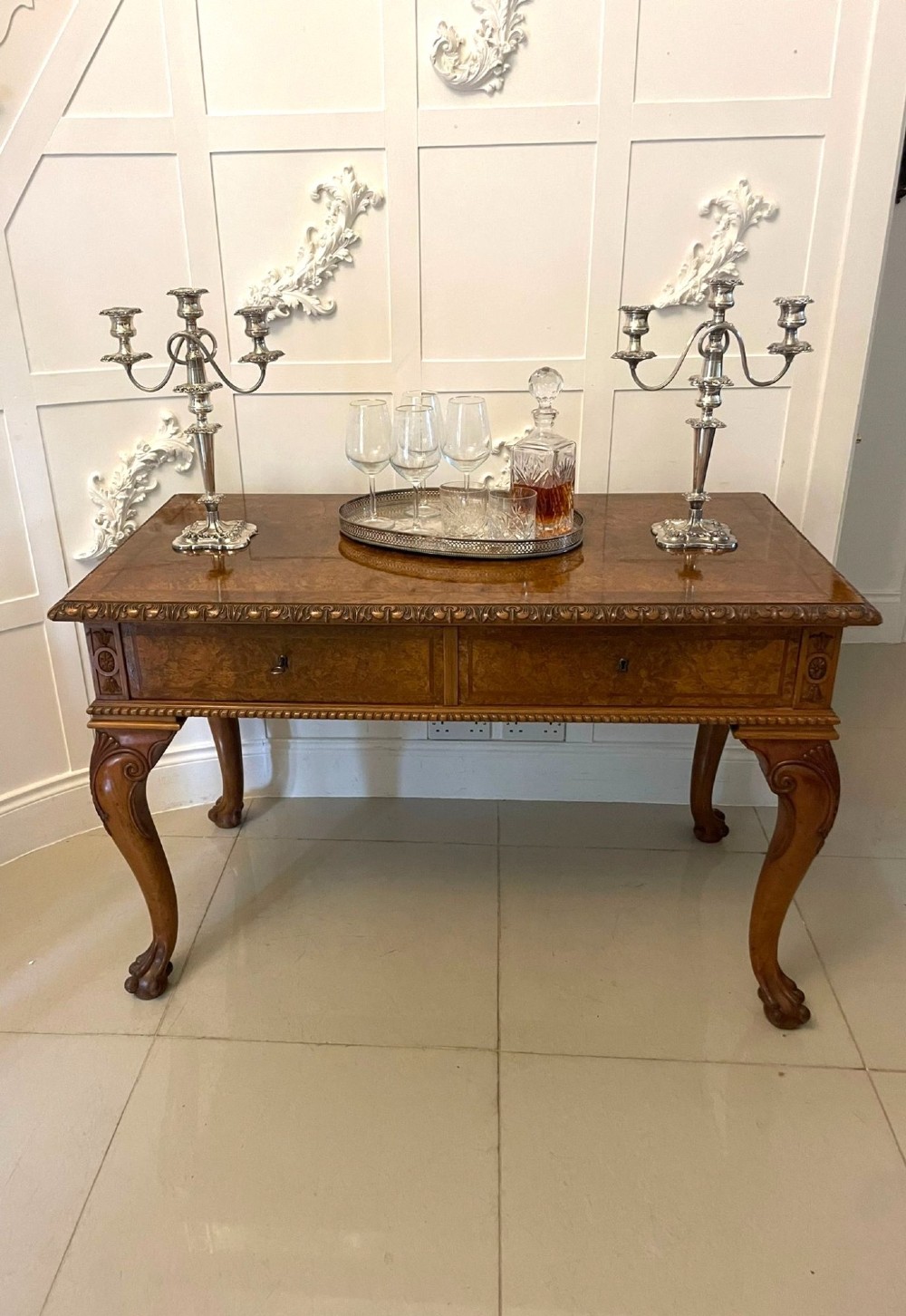 An antique burr walnut console table featuring two drawers, intricate carved moulding along the frame, and carved cabriole legs ending in claw feet. View II