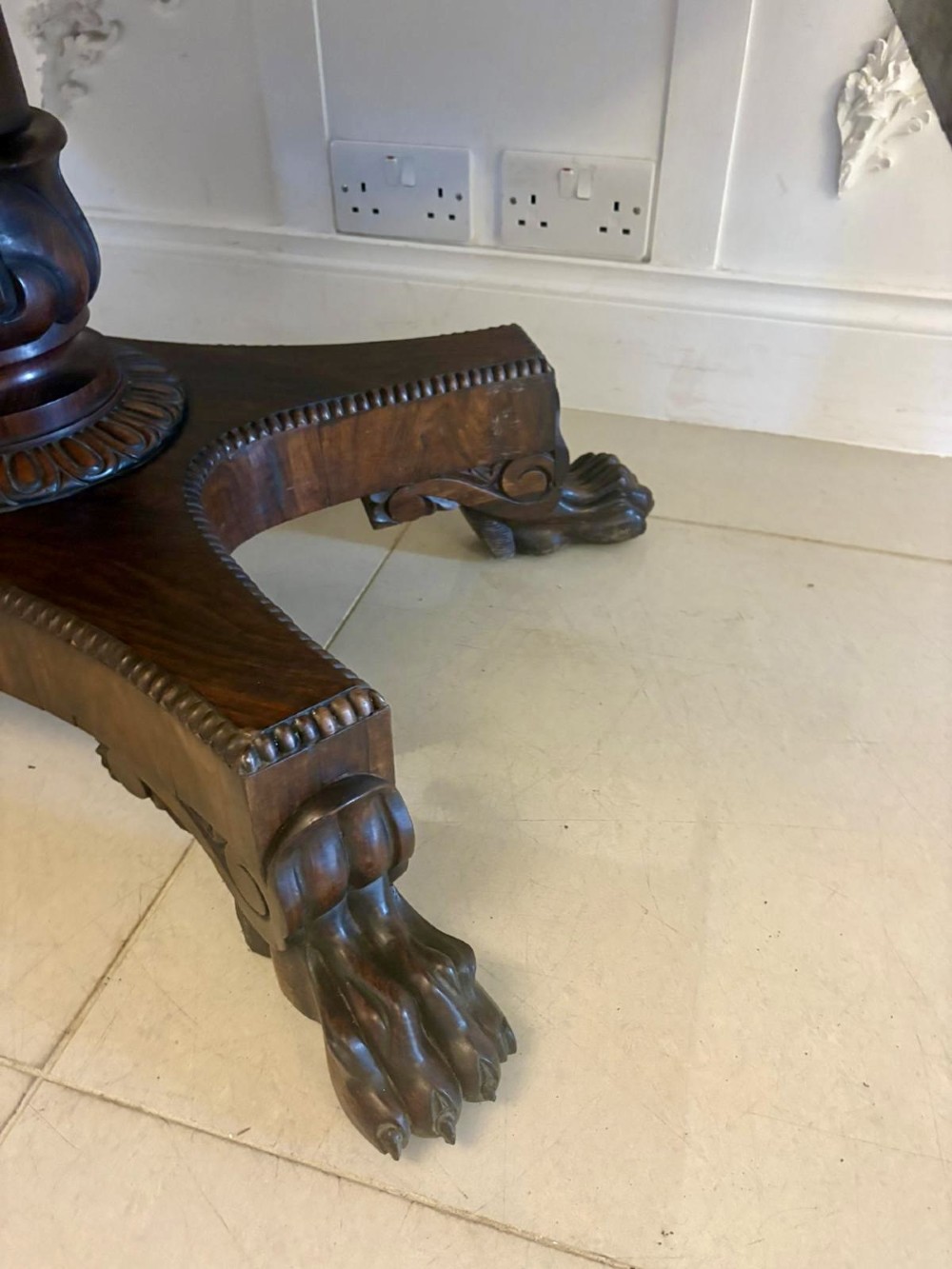 A Regency dark rosewood drop-leaf sofa table with a turned pedestal base and carved claw feet. View X