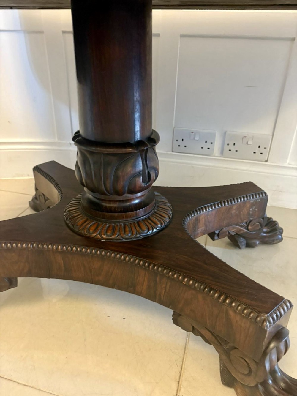 A Regency dark rosewood drop-leaf sofa table with a turned pedestal base and carved claw feet. View XII