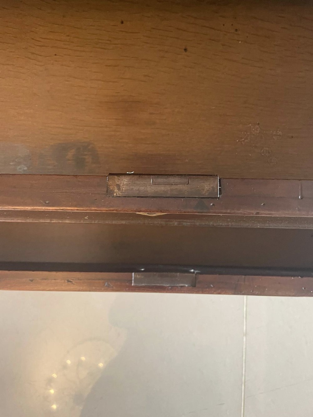 A George II figured mahogany bureau bookcase featuring shaped panel upper doors above a slant-front writing slope and four graduated drawers on bracket feet. View XV
