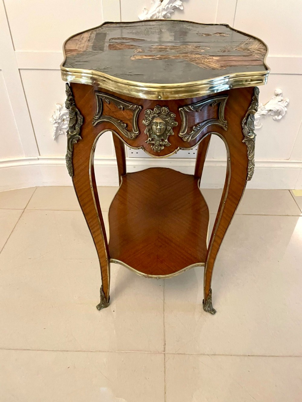 A nineteenth-century French kingwood centre table with serpentine edges, pictorial marquetry top, ormolu mounts, cabriole legs, and a lower shelf. View II
