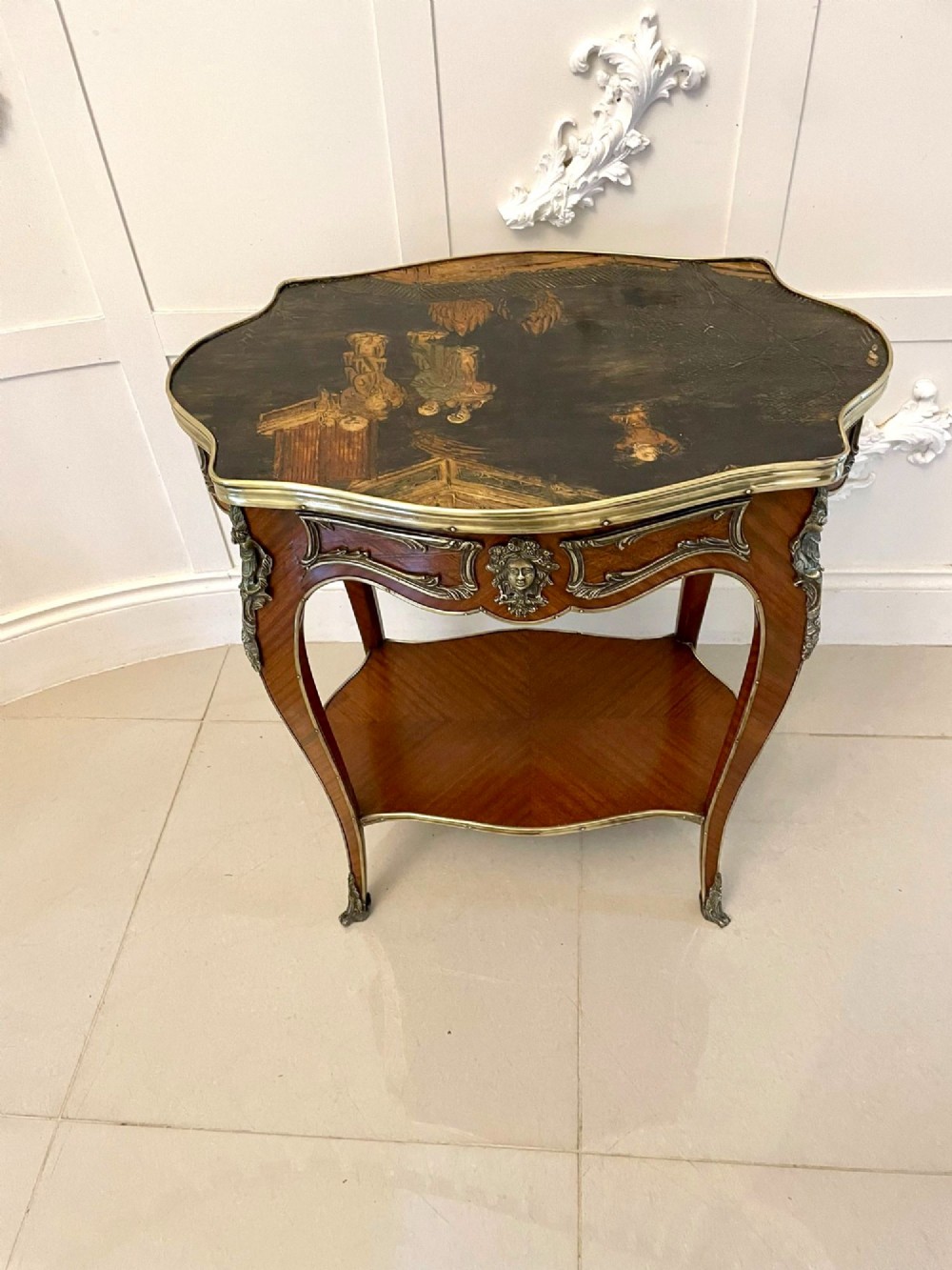 A nineteenth-century French kingwood centre table with serpentine edges, pictorial marquetry top, ormolu mounts, cabriole legs, and a lower shelf. View III