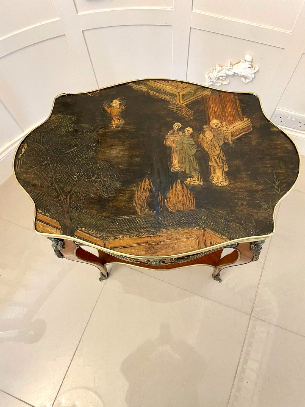 A nineteenth-century French kingwood centre table with serpentine edges, pictorial marquetry top, ormolu mounts, cabriole legs, and a lower shelf. View VI