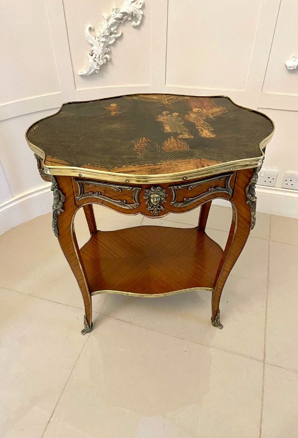 A nineteenth-century French kingwood centre table with serpentine edges, pictorial marquetry top, ormolu mounts, cabriole legs, and a lower shelf. View VII