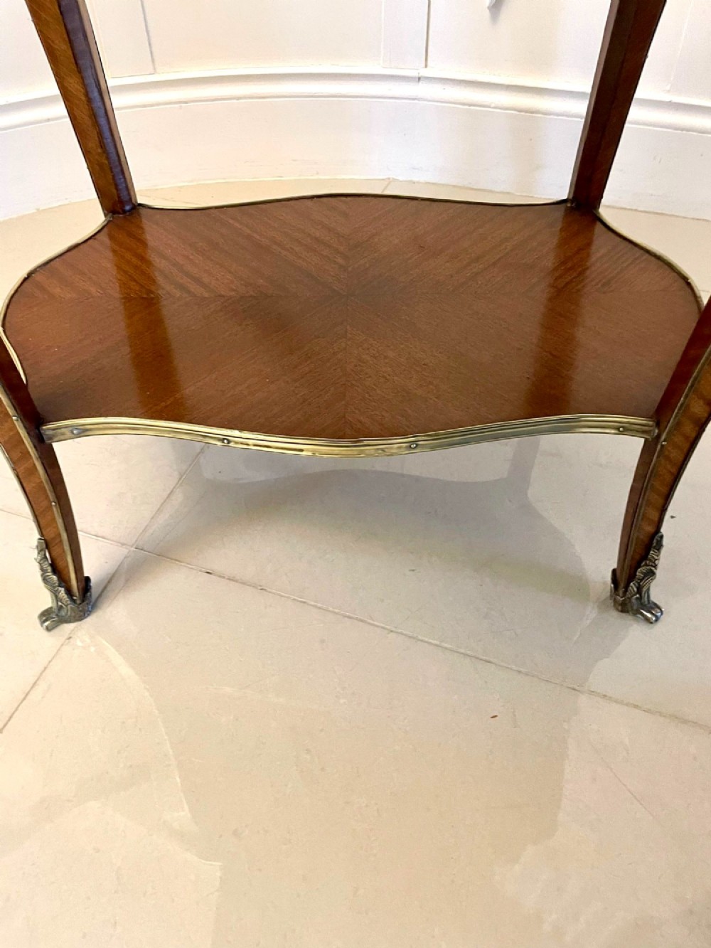 A nineteenth-century French kingwood centre table with serpentine edges, pictorial marquetry top, ormolu mounts, cabriole legs, and a lower shelf. View VIII