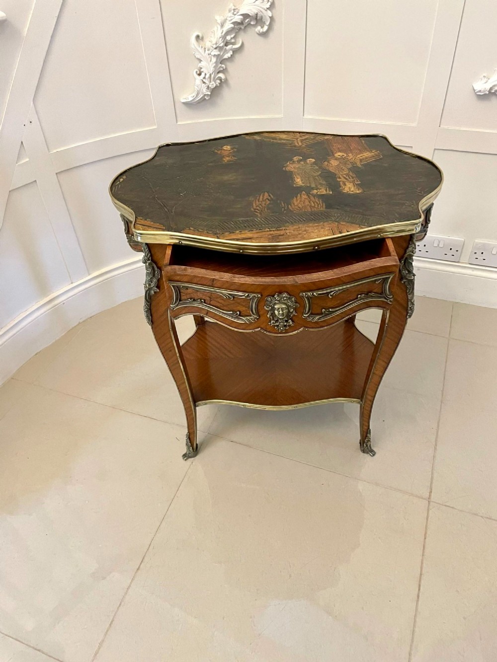 A nineteenth-century French kingwood centre table with serpentine edges, pictorial marquetry top, ormolu mounts, cabriole legs, and a lower shelf. View XI