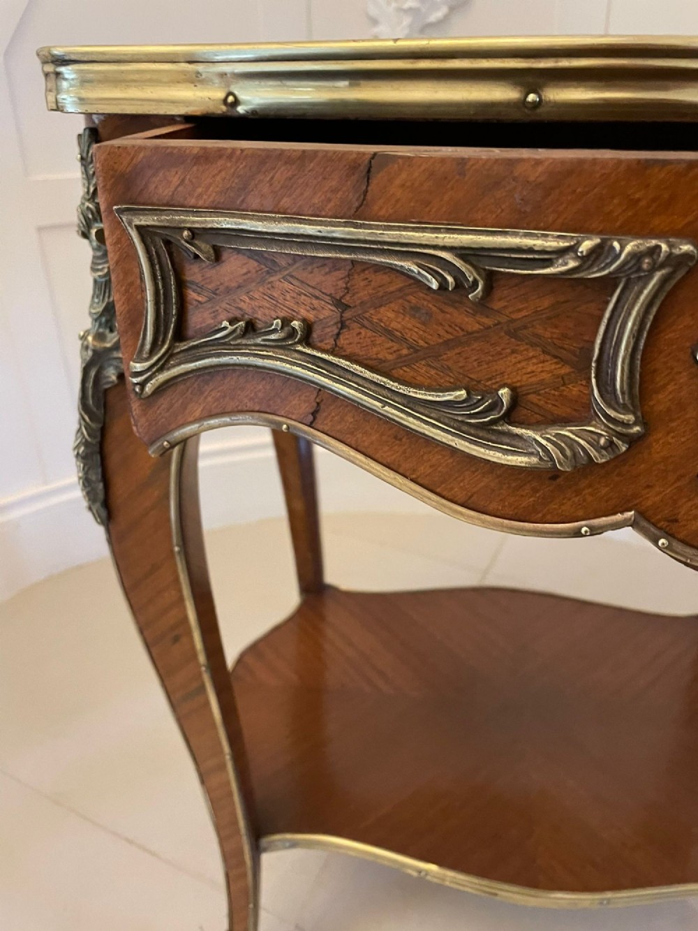 A nineteenth-century French kingwood centre table with serpentine edges, pictorial marquetry top, ormolu mounts, cabriole legs, and a lower shelf. View XII