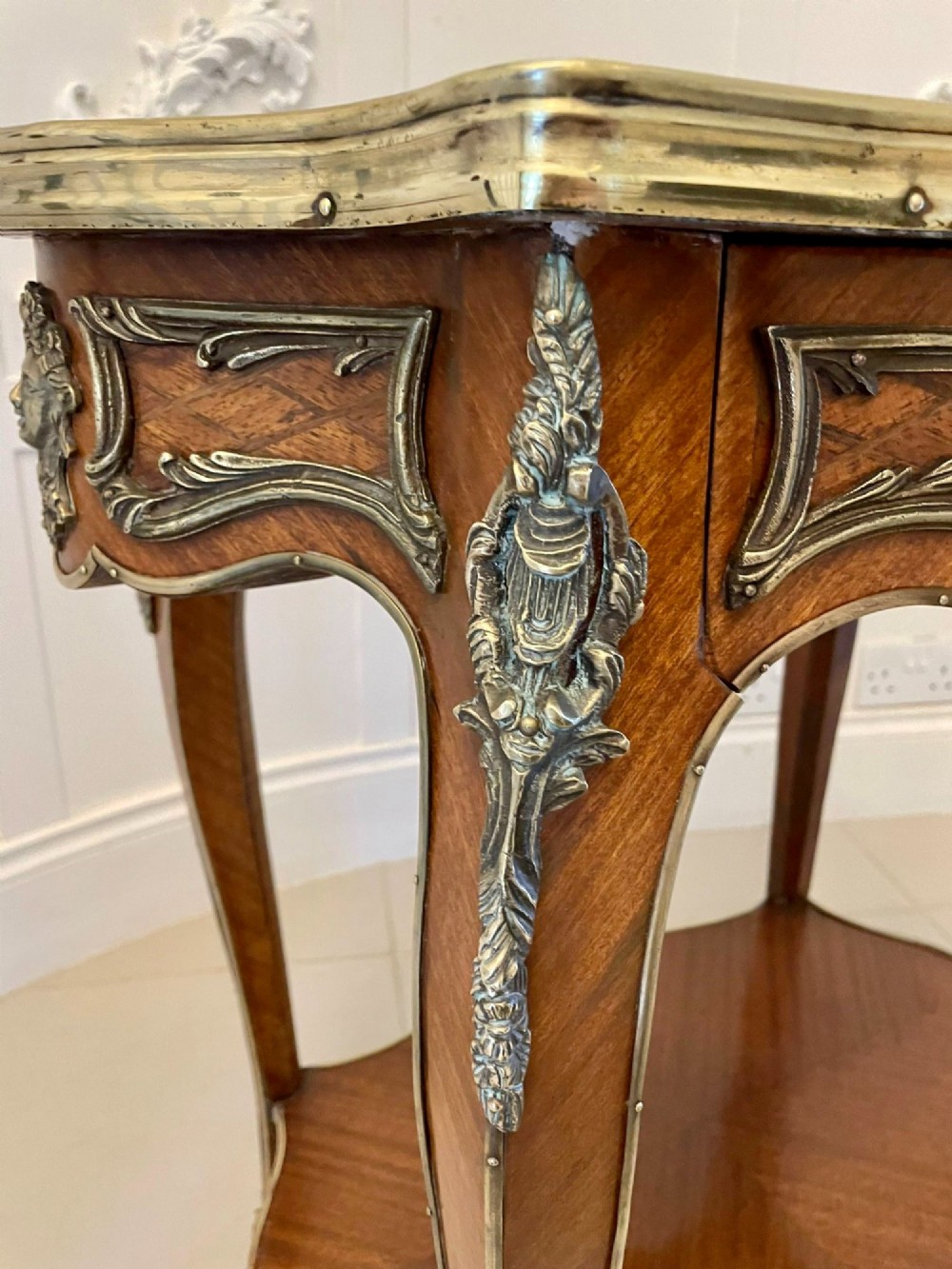 A nineteenth-century French kingwood centre table with serpentine edges, pictorial marquetry top, ormolu mounts, cabriole legs, and a lower shelf. View XIII