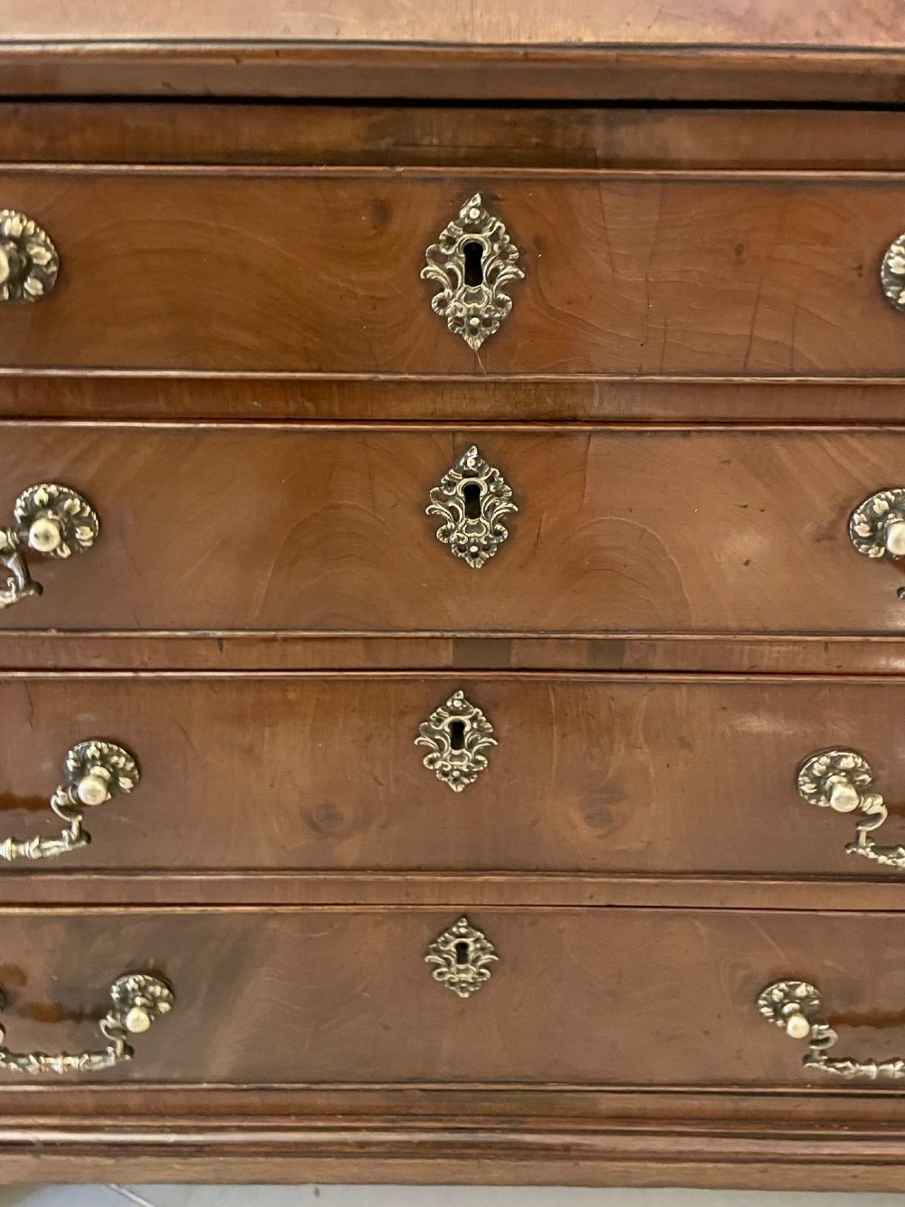 An 18th-century George III mahogany bureau featuring a slant front writing slope above four graduated drawers with brass handles on bracket feet. View VI