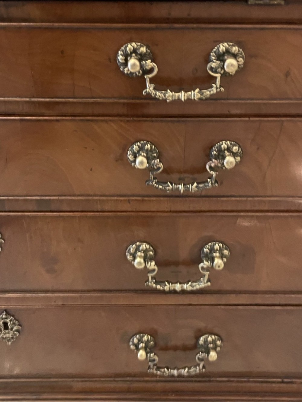 An 18th-century George III mahogany bureau featuring a slant front writing slope above four graduated drawers with brass handles on bracket feet. View VII