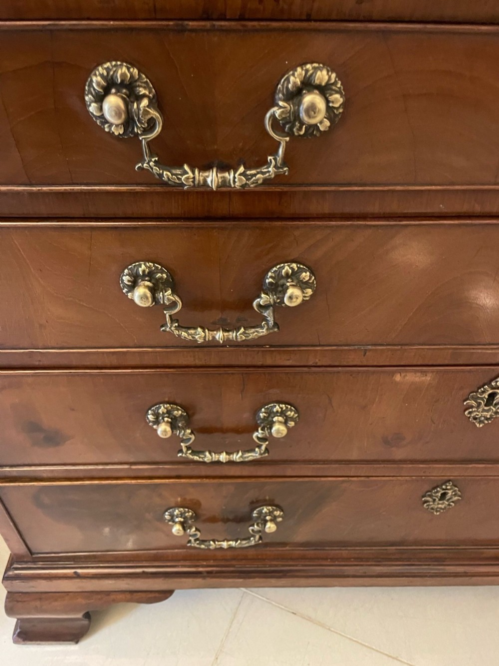 An 18th-century George III mahogany bureau featuring a slant front writing slope above four graduated drawers with brass handles on bracket feet. View VIII