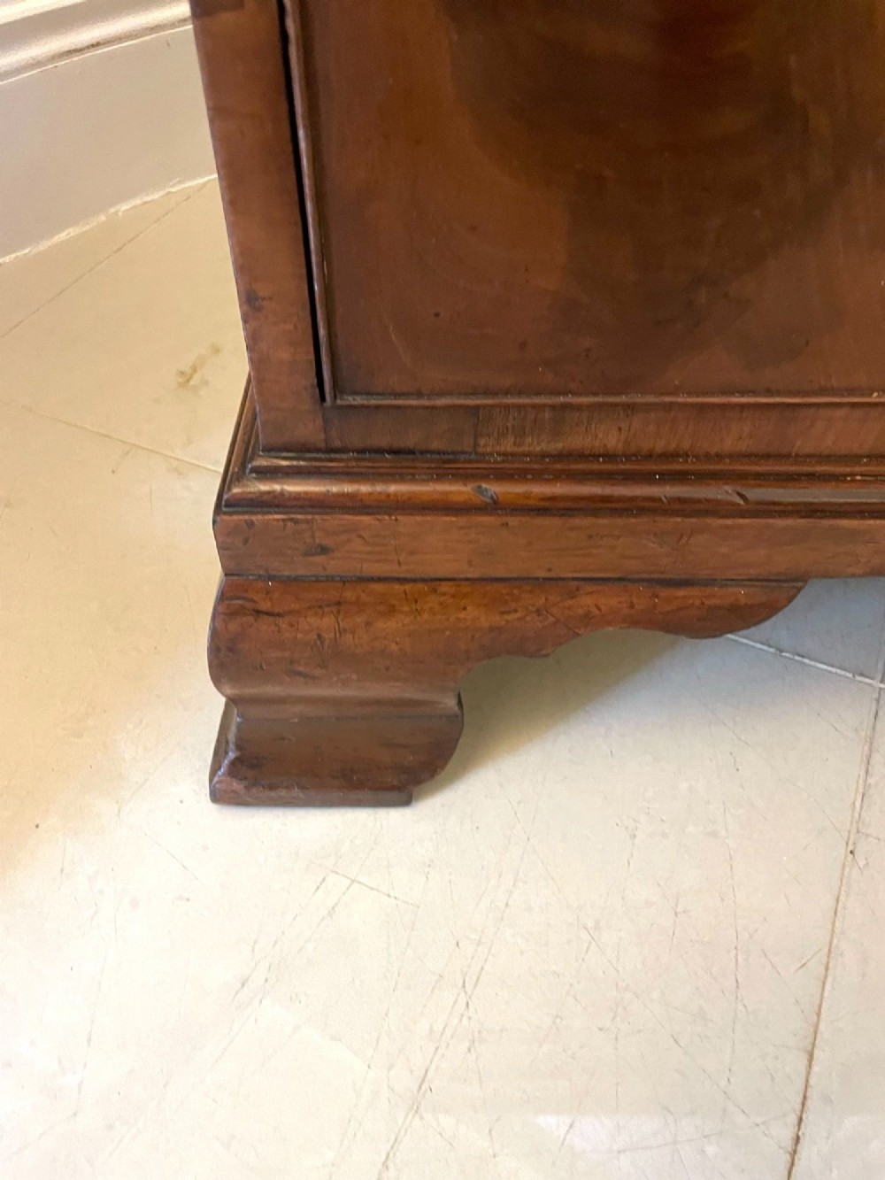An 18th-century George III mahogany bureau featuring a slant front writing slope above four graduated drawers with brass handles on bracket feet. View IX