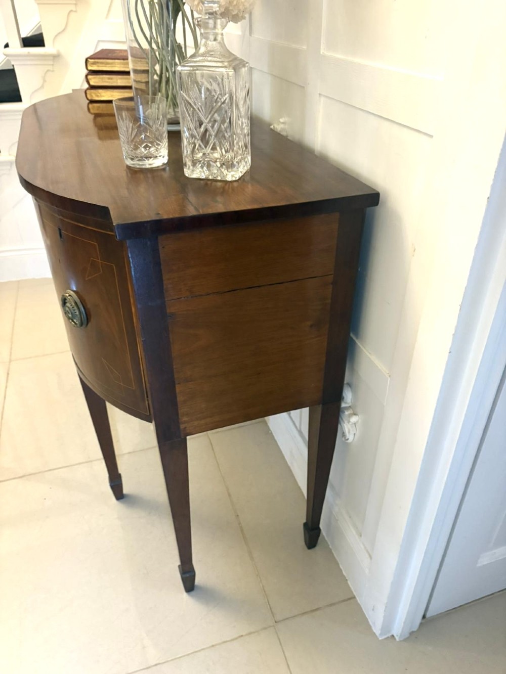 A George III mahogany sideboard featuring geometric boxwood stringing inlay, brass rosette handles, a central arch drawer, and square tapered legs. View III