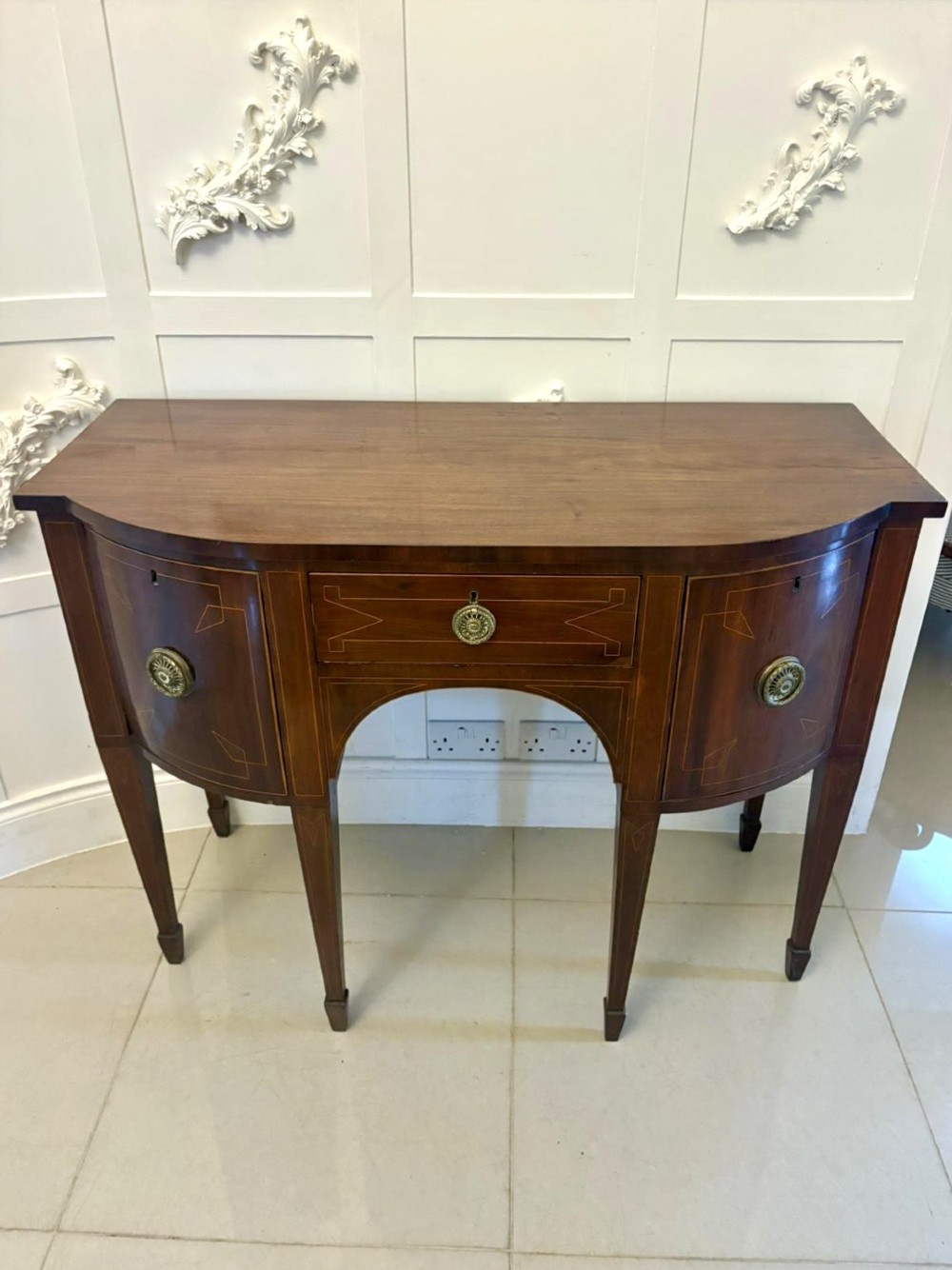 A George III mahogany sideboard featuring geometric boxwood stringing inlay, brass rosette handles, a central arch drawer, and square tapered legs. View IV