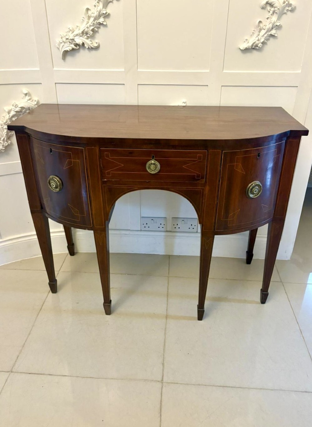 A George III mahogany sideboard featuring geometric boxwood stringing inlay, brass rosette handles, a central arch drawer, and square tapered legs. View VIII