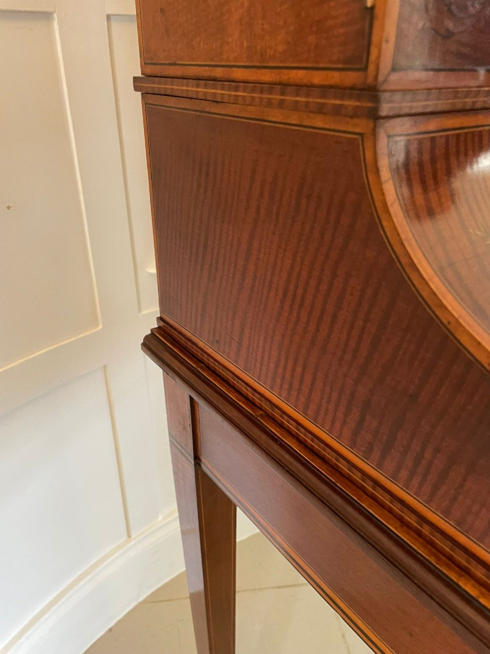A Victorian inlaid mahogany writing desk featuring a brass gallery top, mirrored arched niche, floral marquetry cabinets, small drawers, and tapered square legs. View III