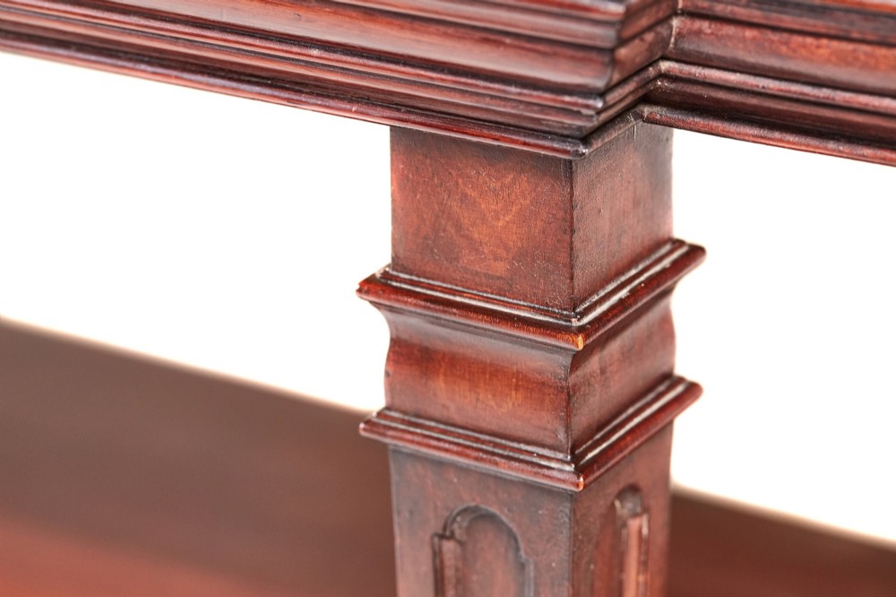A Victorian mahogany breakfront display cabinet with astragal glazed doors, open side shelves, and a swan-neck pediment topped with an urn finial. View IV