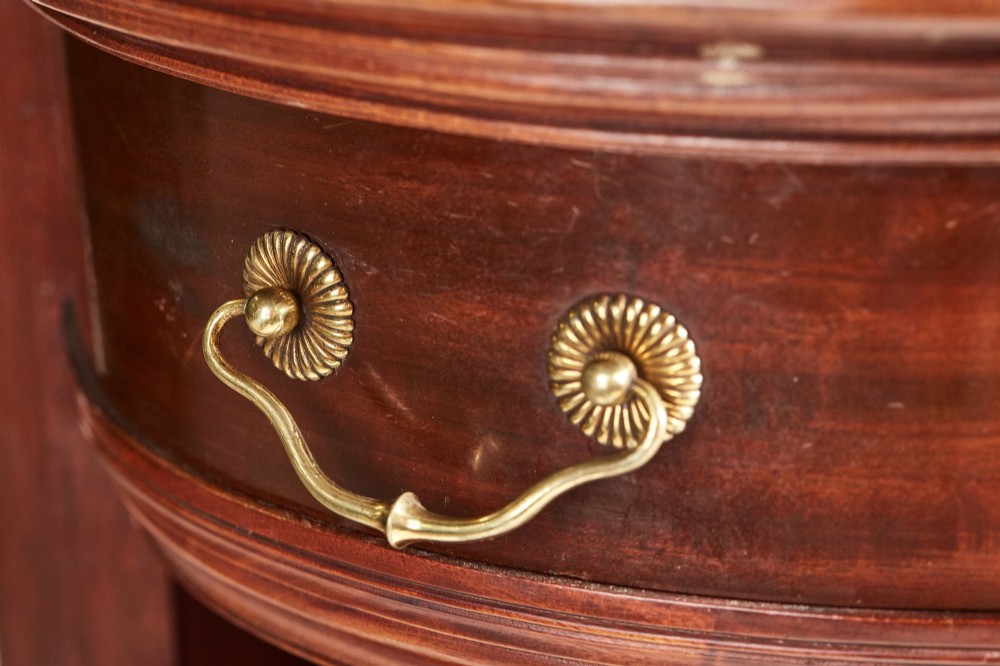 A Victorian mahogany breakfront display cabinet with astragal glazed doors, open side shelves, and a swan-neck pediment topped with an urn finial. View VI