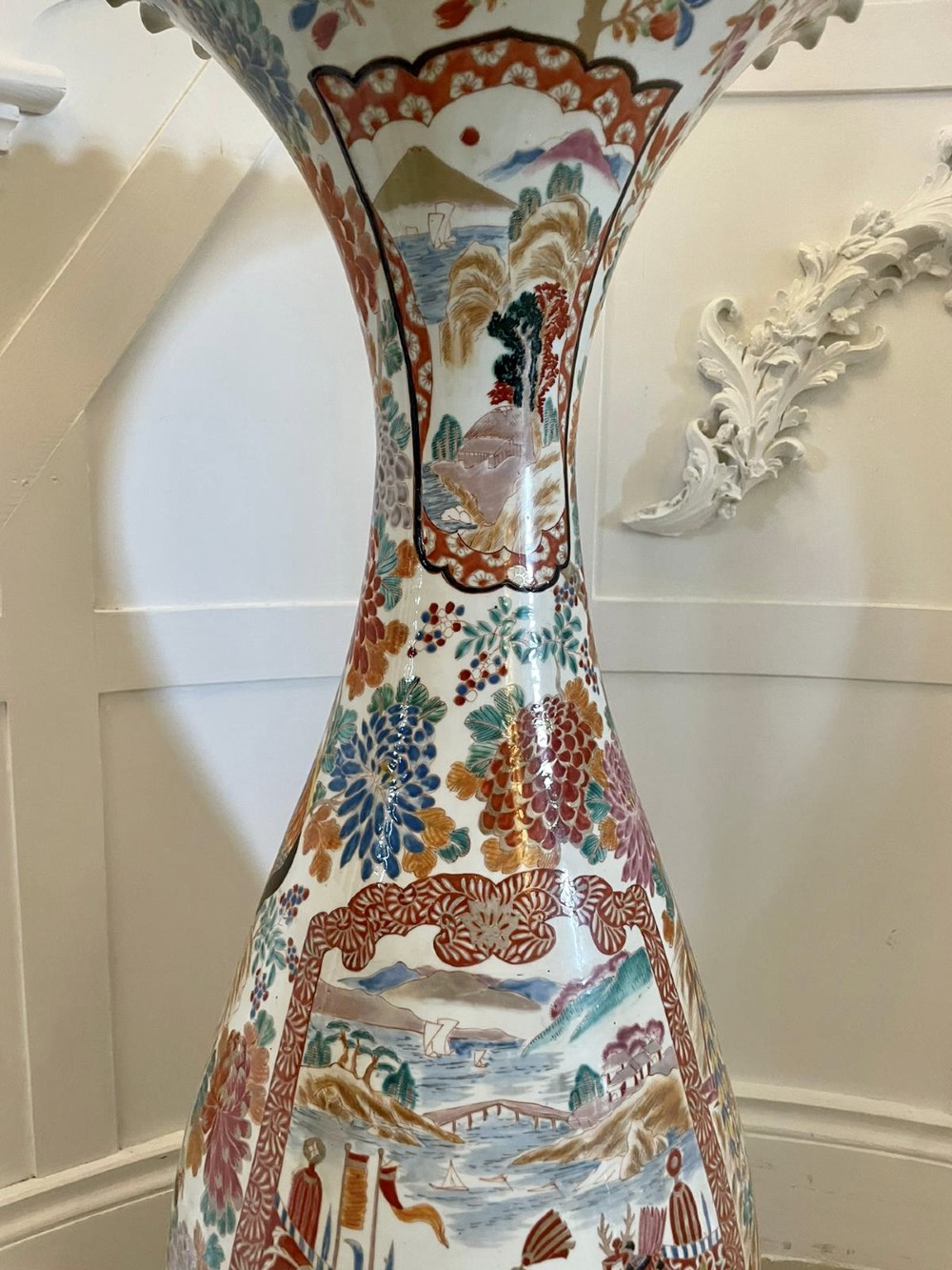A tall 19th-century Japanese Imari porcelain floor-standing vase featuring polychrome enamel figurative scenes, floral motifs, and a fluted frilled rim. View II