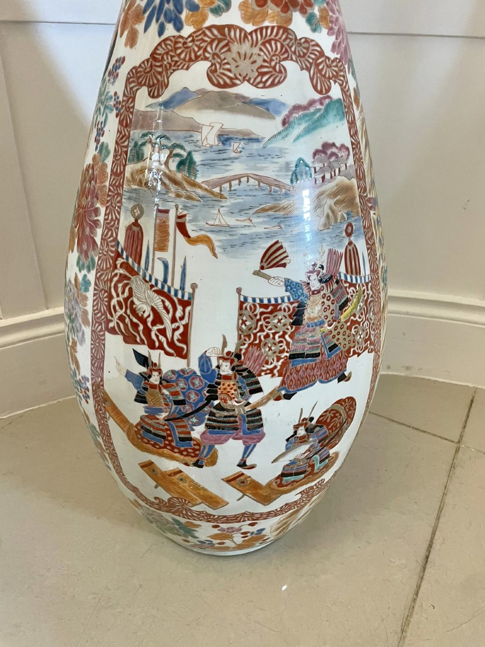 A tall 19th-century Japanese Imari porcelain floor-standing vase featuring polychrome enamel figurative scenes, floral motifs, and a fluted frilled rim. View III