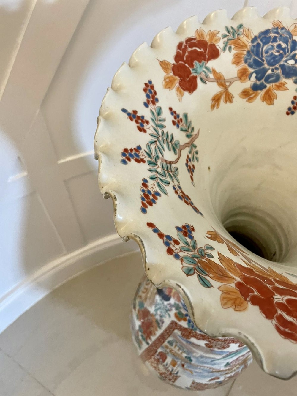 A tall 19th-century Japanese Imari porcelain floor-standing vase featuring polychrome enamel figurative scenes, floral motifs, and a fluted frilled rim. View X