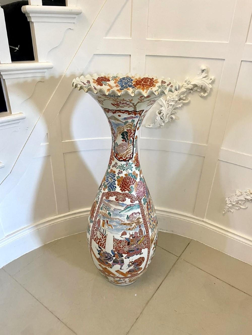 A tall 19th-century Japanese Imari porcelain floor-standing vase featuring polychrome enamel figurative scenes, floral motifs, and a fluted frilled rim. View XIII