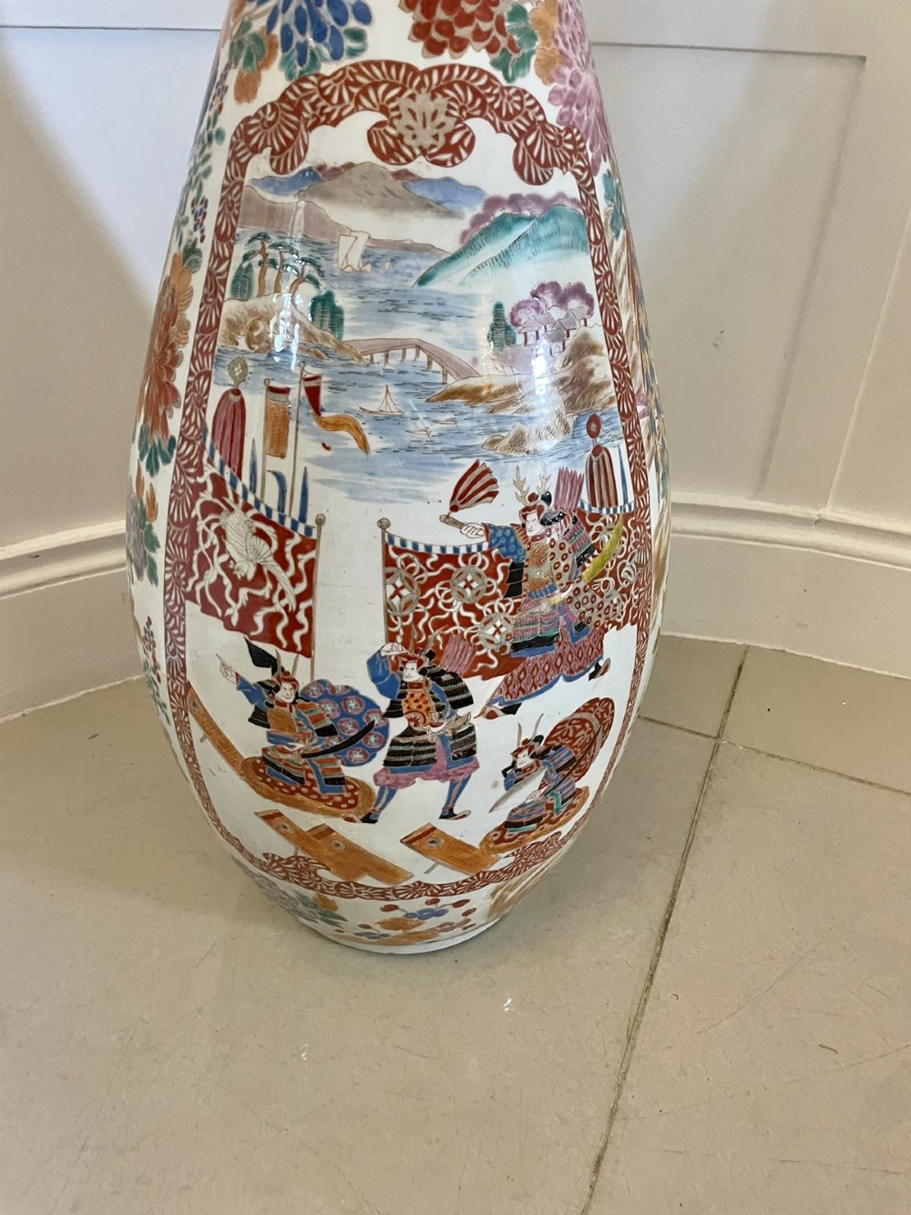 A tall 19th-century Japanese Imari porcelain floor-standing vase featuring polychrome enamel figurative scenes, floral motifs, and a fluted frilled rim. View XIV