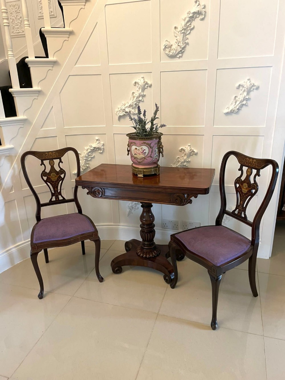 A William IV mahogany fold-over tea table with a turned gadrooned pedestal stem and a concave quadform base ending in scroll feet. View III