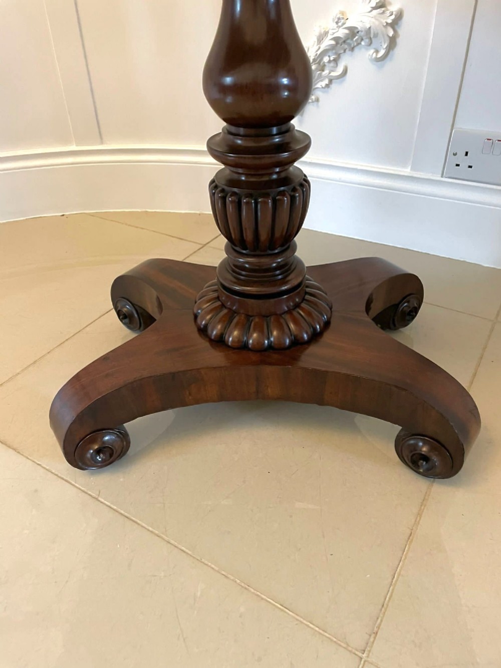 A William IV mahogany fold-over tea table with a turned gadrooned pedestal stem and a concave quadform base ending in scroll feet. View XIII