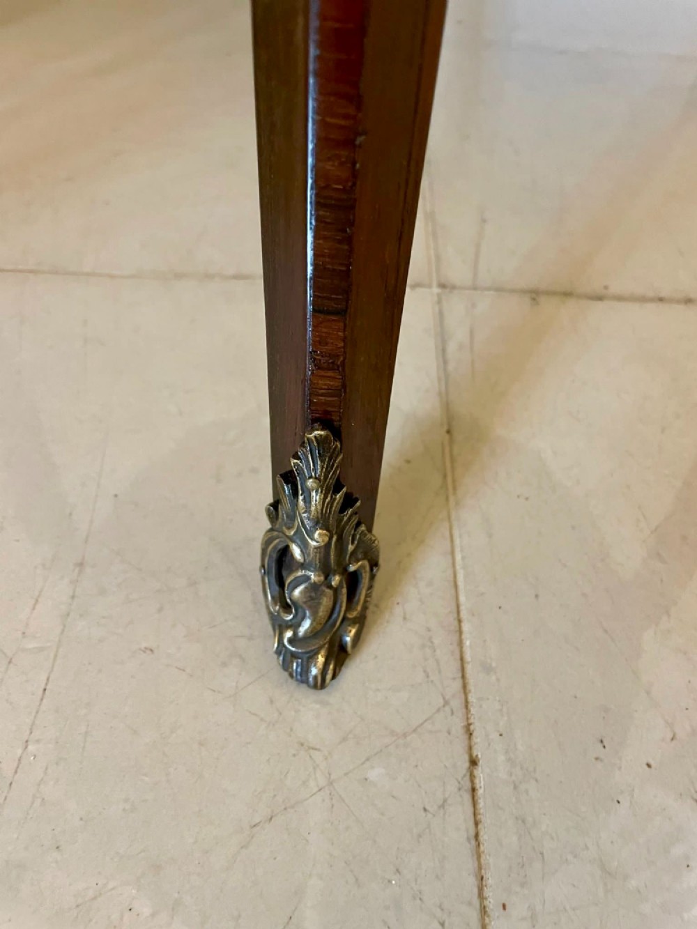 A circular French centre table with a grey marble top, kingwood veneered apron, metal mount, and curved cabriole legs. View VIII