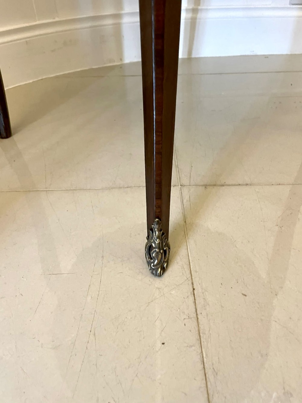 A circular French centre table with a grey marble top, kingwood veneered apron, metal mount, and curved cabriole legs. View XI