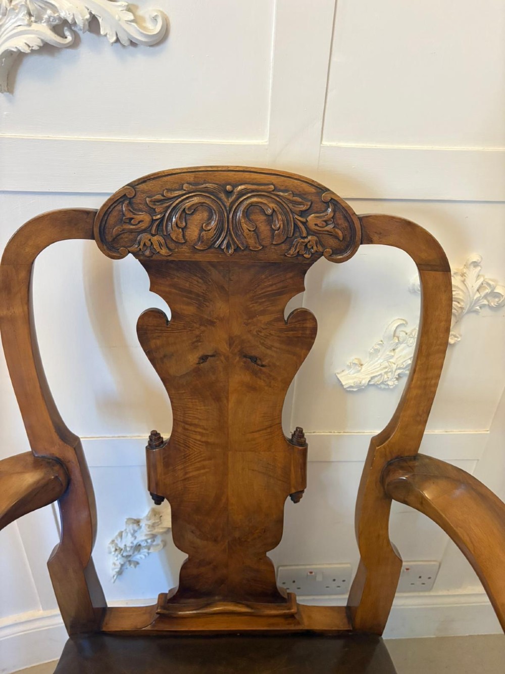 A set of six carved walnut dining chairs featuring decorative back splats, leather seats with brass studs, cabriole legs, and ball and claw feet. View IV