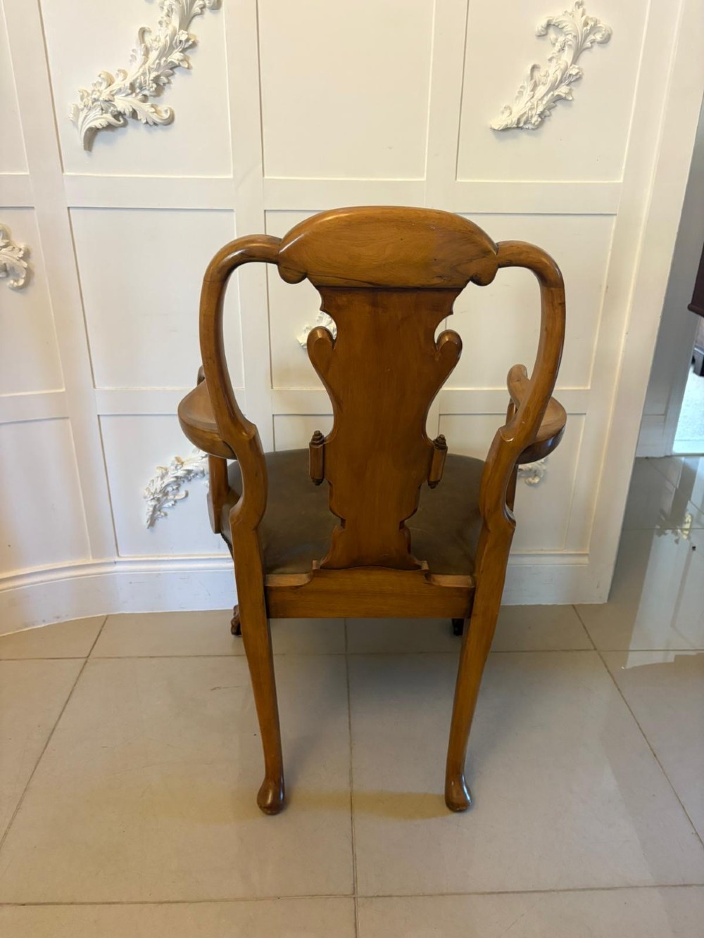 A set of six carved walnut dining chairs featuring decorative back splats, leather seats with brass studs, cabriole legs, and ball and claw feet. View VII