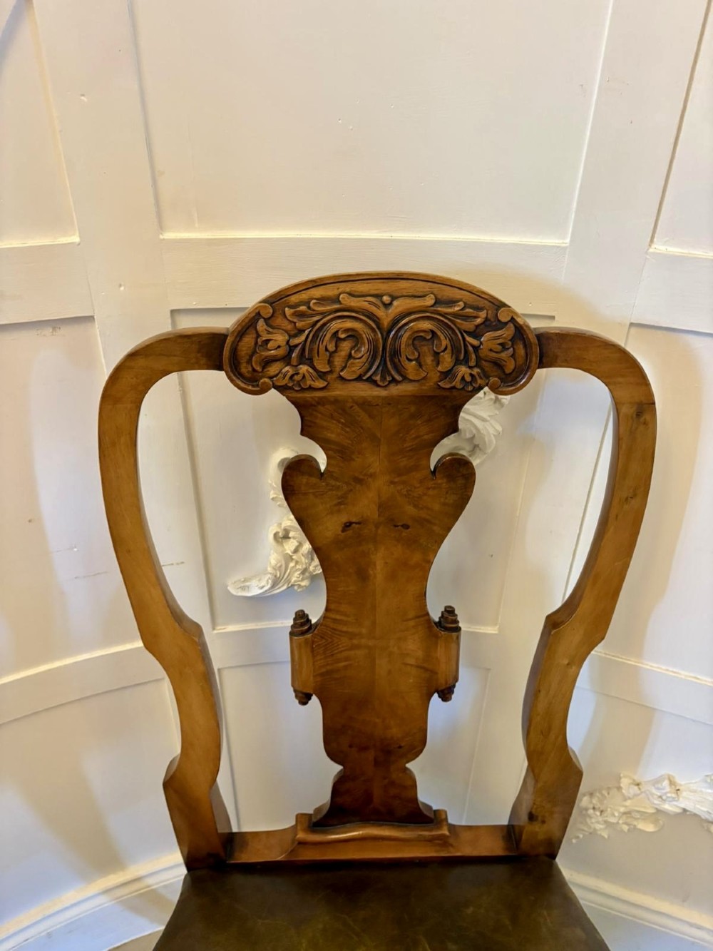 A set of six carved walnut dining chairs featuring decorative back splats, leather seats with brass studs, cabriole legs, and ball and claw feet. View XII