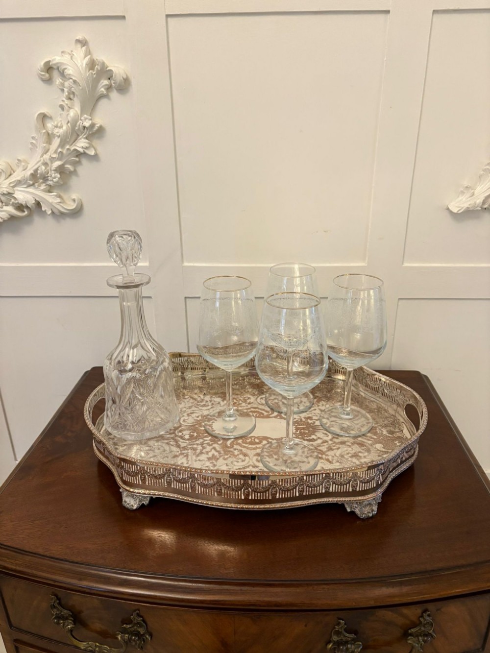 A silver-plated Edwardian tea tray featuring an engraved surface, a pierced gallery border with integrated handles, and cast feet. View IV