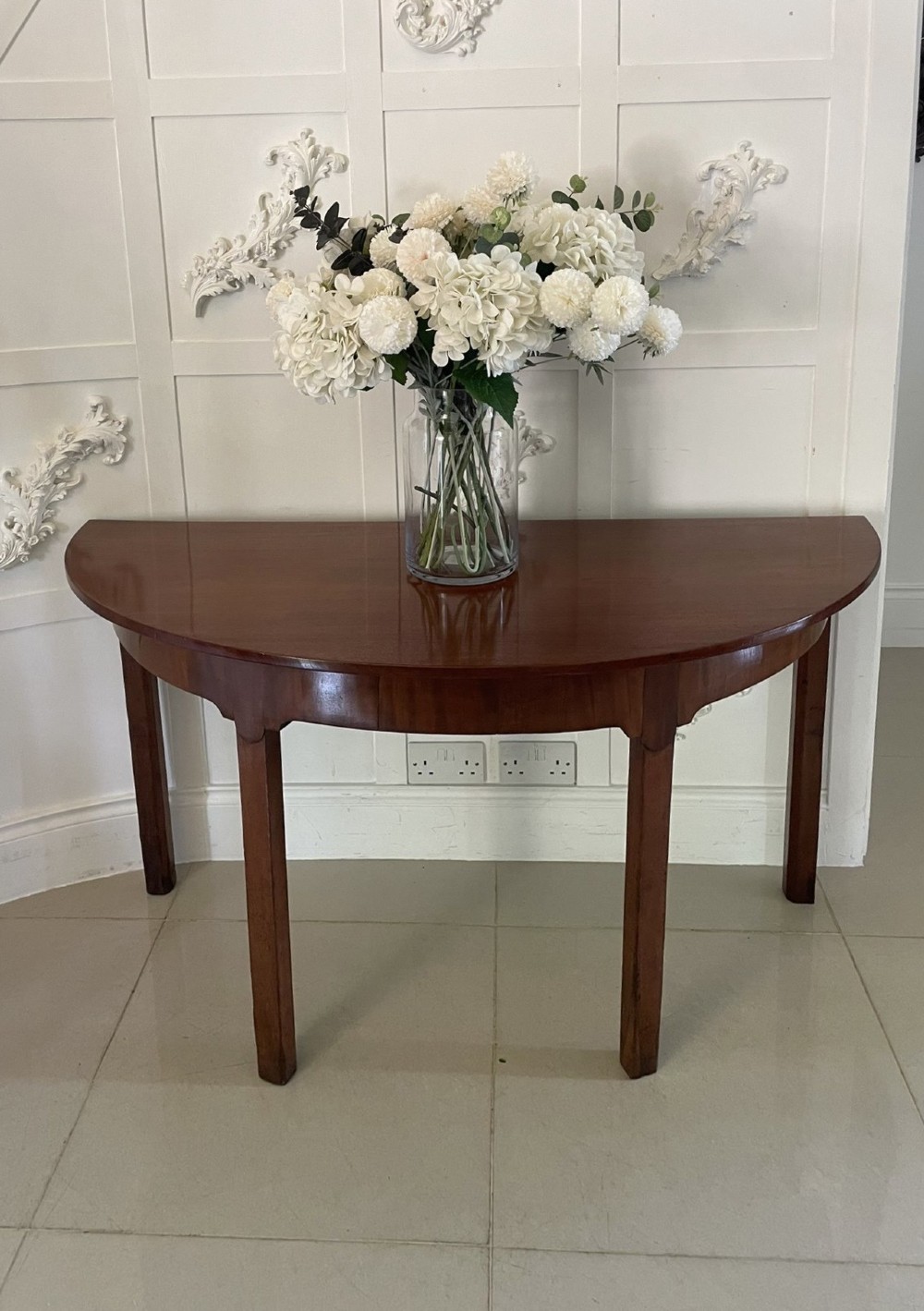 A pair of George III mahogany demi-lune console tables with polished semi-circular tops and straight tapered legs. View III