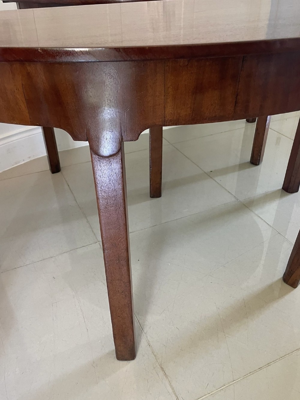 A pair of George III mahogany demi-lune console tables with polished semi-circular tops and straight tapered legs. View IX
