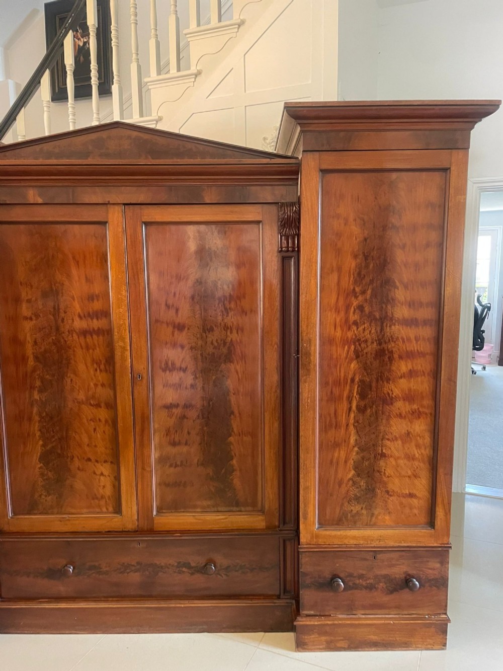 A large Victorian breakfront mahogany four-door wardrobe featuring figured wood veneer panels and lower base drawers. View VIII