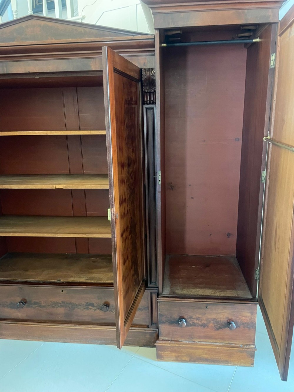 A large Victorian breakfront mahogany four-door wardrobe featuring figured wood veneer panels and lower base drawers. View IX