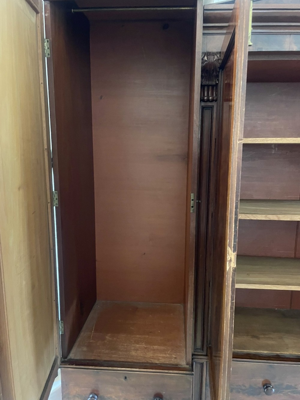 A large Victorian breakfront mahogany four-door wardrobe featuring figured wood veneer panels and lower base drawers. View XI