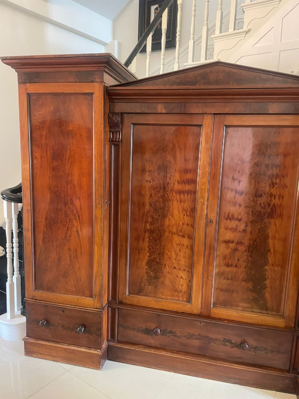 A large Victorian breakfront mahogany four-door wardrobe featuring figured wood veneer panels and lower base drawers. View XIII